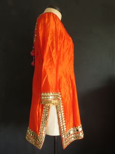 "The embellishment on this stunning outfit is magnificent! It's a very dramatic show-stopper outfit for a special occasion, when you want to make a statement. The mirror-work is made using real mirror glass! Kameez/Top is made of orange silk. The sleeves are not lined and so are somewhat sheer. There is minor staining under the arms. Features: ♦ wire embroidered mirror-work ♦ copper silk pleated ribbon trim ♦ sweetheart neckline trimmed w/ gold metal disc beads and magenta silk piping ♦ high sid Wedding Salwar Kameez, Salwar Pants, Long Tunic Dress, Peignoir Sets, India Dress, Silk Taffeta, Purple Silk, Stunning Outfits, Silk Dupatta