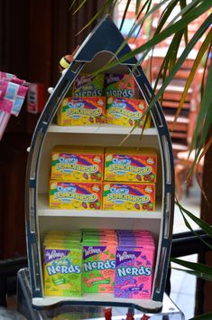 a boat shaped shelf filled with lots of candy