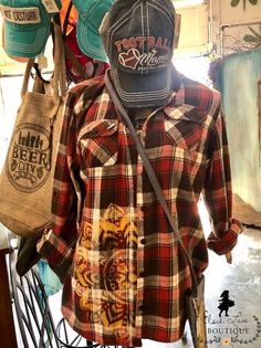 the back of a man's plaid shirt with hats on his head and shoulder