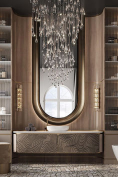 a bathroom with a large mirror and chandelier hanging from it's ceiling