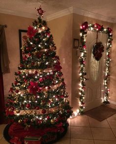 a decorated christmas tree in a living room with lights on the trees and decorations around it