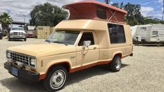 an old truck with a camper attached to it