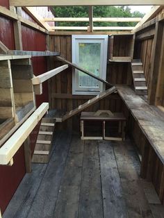 the inside of a chicken coop with wooden floors