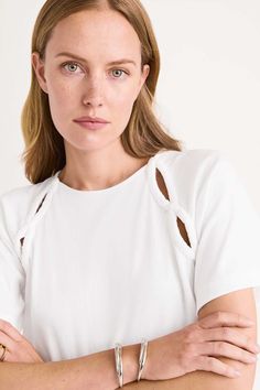 The SOLACE is Merlette's take on the classic jersey tee, foregrounding sustainability and signature details. Crafted in midweight 100% organic cotton jersey, it has a soft handfeel. Serpentine-shaped cut out details at the sleeves are ruched by hand. Cotton Jersey Top, Jersey Tops For Women, Brand Boards, Neck Lines, Tied T Shirt, Sewing Clothing, Womens Knit Tops, Jersey Tops, Cutout Top