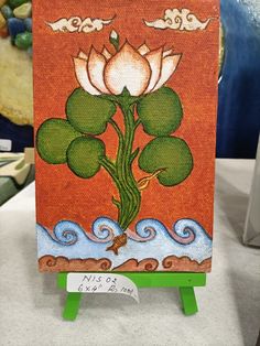 a painting on an easel with water lilies