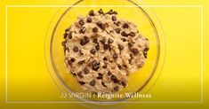 a bowl filled with oatmeal and chocolate chips on top of a yellow background