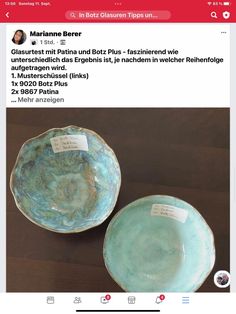 two blue plates sitting on top of a table next to each other with tags attached