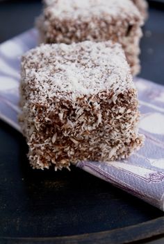 two pieces of cake sitting on top of a plate next to a napkin and fork