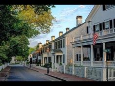 a street lined with white houses and trees