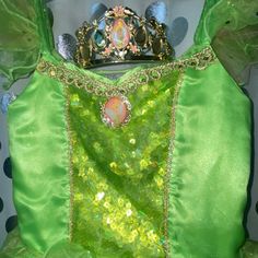 a green dress with a tiara on it