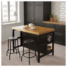 a kitchen island with two stools next to it