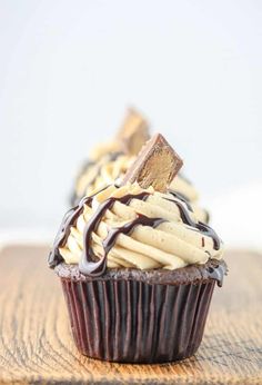 chocolate cupcakes with white frosting and peanut butter on top