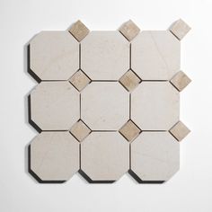 a white and beige tile with hexagonal shapes