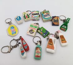 a bunch of different types of key chains on a white surface with one being used as a bottle and the other is empty