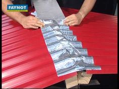 a man is holding aluminum foil on top of a red roof that has been rolled down