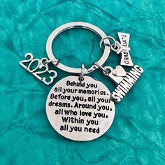 a keychain with the words behind it and an image of a piano on it