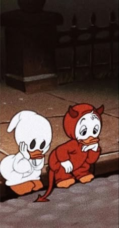 two cartoon characters are sitting on the ground