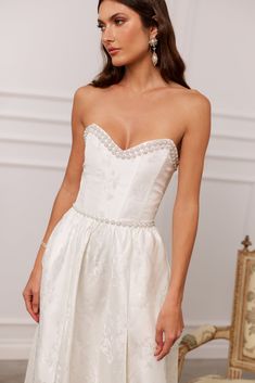 Meet Lucia! She's a stunning strapless corset midi dress adorned with opulent pearl and crystal beaded trim accents. Her sweetheart neckline, side pockets, and side-front slit are cute, flirty, and ready for any party. Made from our coveted White Baroque Floral brocade, which features white florals on a white background, we can't help but fall in love with this beauty. If you are in between sizes, we recommend sizing up in this dress. Kyla is 5’9.5 and is wearing a size 2. Please note color shad Baroque Floral, Corset Midi Dress, Loungewear Dresses, Strapless Sweetheart Neckline, White Florals, Crystal Trim, Strapless Corset, Beaded Trim, Mens Swimwear