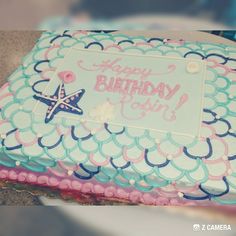 a birthday cake is decorated with blue and pink icing