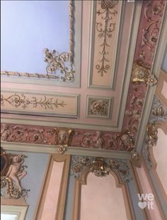 the ceiling is painted in pink and gold