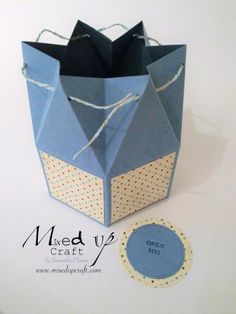 an origami box with a tag attached to it