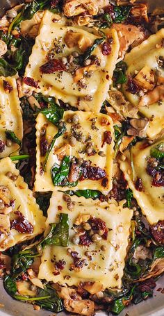 a pan filled with pasta and spinach covered in cheese