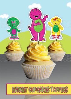 three cupcakes with yellow frosting and dinosaur toppers on them, in front of a blue sky