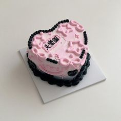 a heart shaped cake sitting on top of a white table