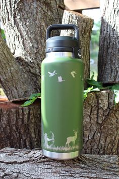 a green water bottle sitting on top of a tree