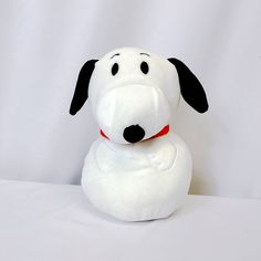 a stuffed dog sitting on top of a white surface