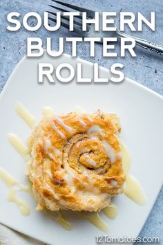 a white plate topped with a pastry covered in icing