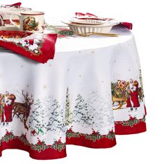 a table topped with a white and red christmas table cloth covered in santa's sleigh