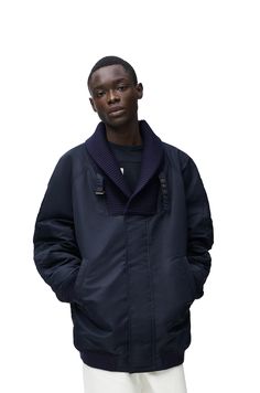 Techwear Outerwear With Padded Collar In Nylon, Nylon Techwear Outerwear With Ribbed Cuffs, Navy Nylon Outerwear For Fall, Winter Nylon Outerwear With Ribbed Collar, Winter Workwear Windbreaker With Padded Collar, Winter Windbreaker With Padded Collar, Navy Nylon Winter Windbreaker, Navy Nylon Windbreaker For Winter, Winter Techwear Windbreaker For Work