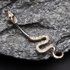 Add some extra sparkle to your belly button with our Golden Snake Sparkle Belly Button Ring. The elegant design features a golden snake, perfect for adding a touch of sophistication to any piercing. Get ready to dazzle and shine with this unique accessory. * Material: 316L Stainless Steel Gold Plated * Bar Size: 14 GA (1.6mm), 10mm (3/8") * Length: 0.9 inch (22mm) * Width: 0.3 inch (7mm) Suitable for * Navel Piercings It is always recommended to know your exact piercing size to ensure fitment, s Heavy Sweating, Golden Snake, Navel Piercing, Belly Button, Belly Rings, Body Jewellery, Accessories Unique, Jewelry Plate, Body Jewelry