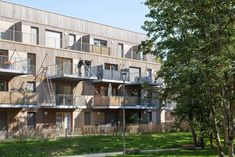 an apartment building with balconies on the second floor