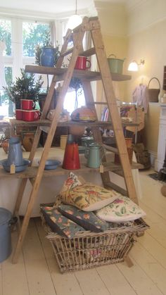 a wooden ladder sitting in the middle of a room