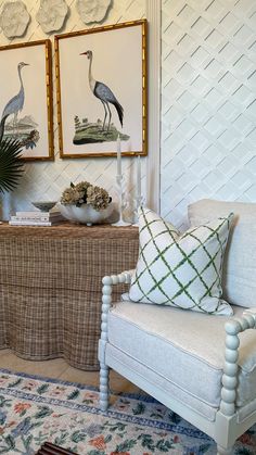 a living room filled with furniture and pictures on the wall