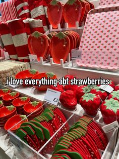 red and green strawberries are on display in a store with the words i love everything at strawberries