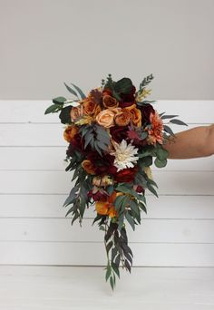 a bridal bouquet with orange and red flowers