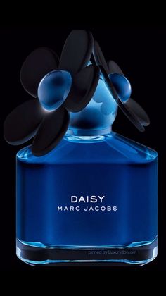 a blue bottle with black flowers in it's top and the words daisy marc jumbobobs