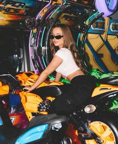 a woman sitting on the back of a motorcycle in front of a slot machines machine