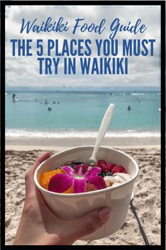 a person holding a bowl of food on the beach with text overlay that reads waiki's food guide the 5 places you must try in waiki