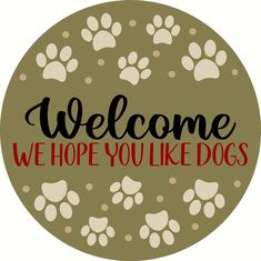 a sign that says, welcome we hope you like dogs with paw prints on it