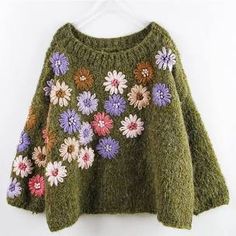 a green sweater with colorful flowers on it