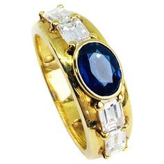 a gold ring with blue and white stones