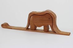 a wooden toy elephant on a white background