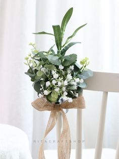 a bouquet of flowers tied to a chair