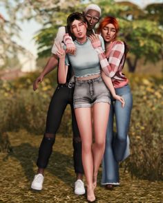 three people are standing in the grass with one woman holding her arm around another person