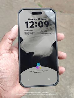 someone is holding up their iphone with the clock displayed on it's display screen