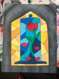 a stained glass window with a rose on it